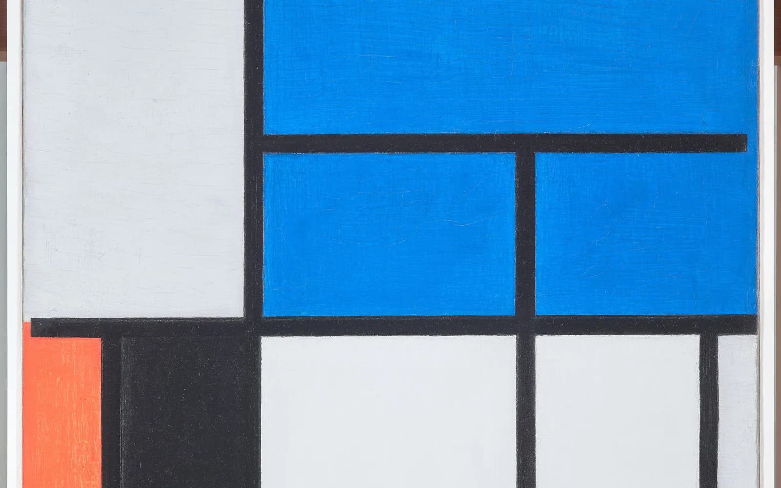 Mondrian's Composition with Large Blue Plane: a grid of thick black lines dividing the canvas into blue, grey, black and red rectangles.