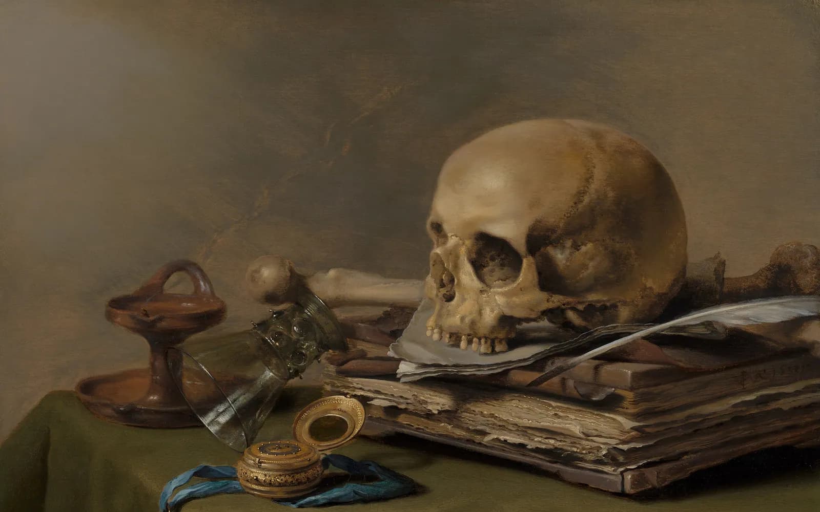 Pieter Claesz still life of a skull resting on old books beside a quill, a toppled glass, an oil lamp and an open pocket watch on a green tablecloth.